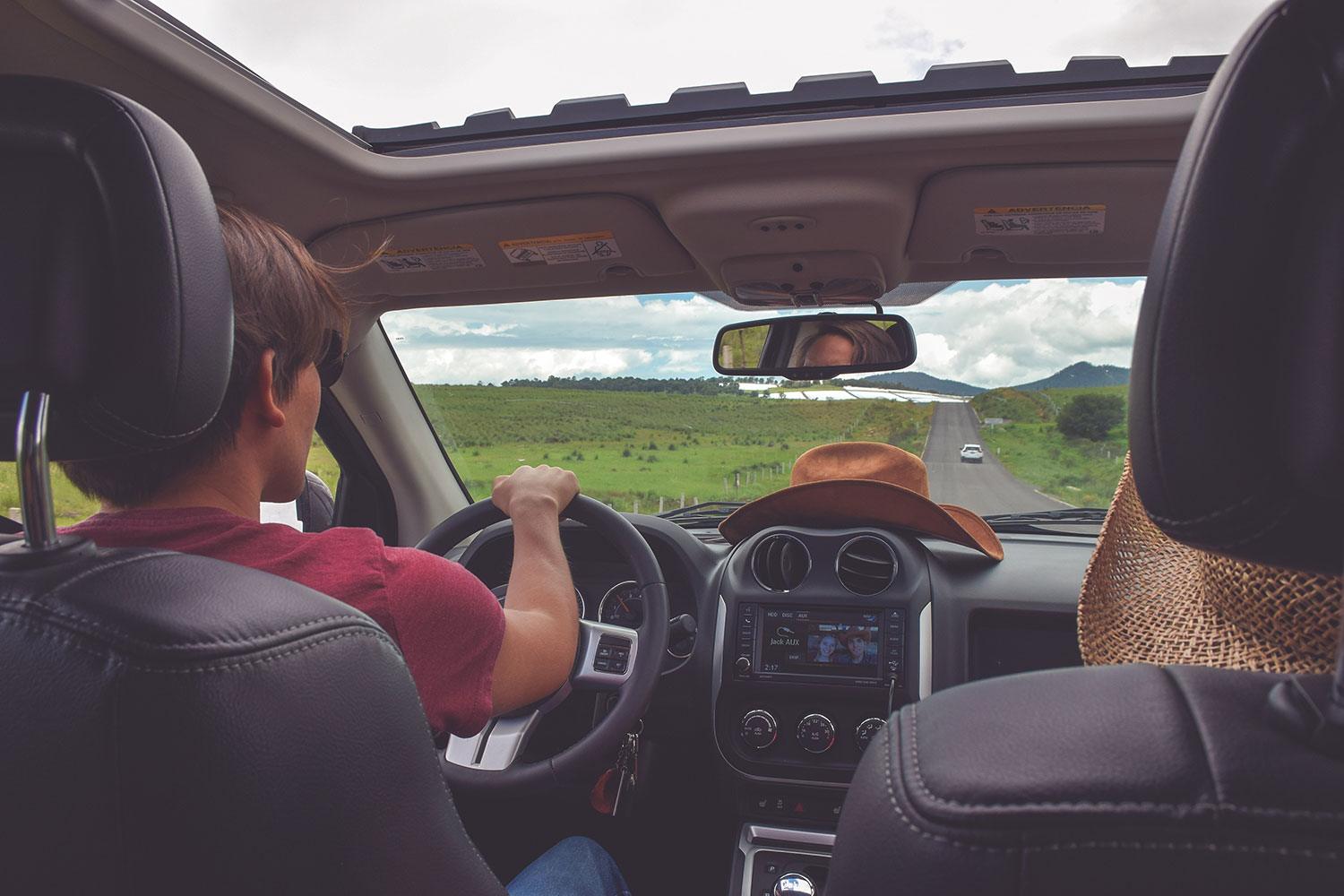 Image of couple in a car on the road